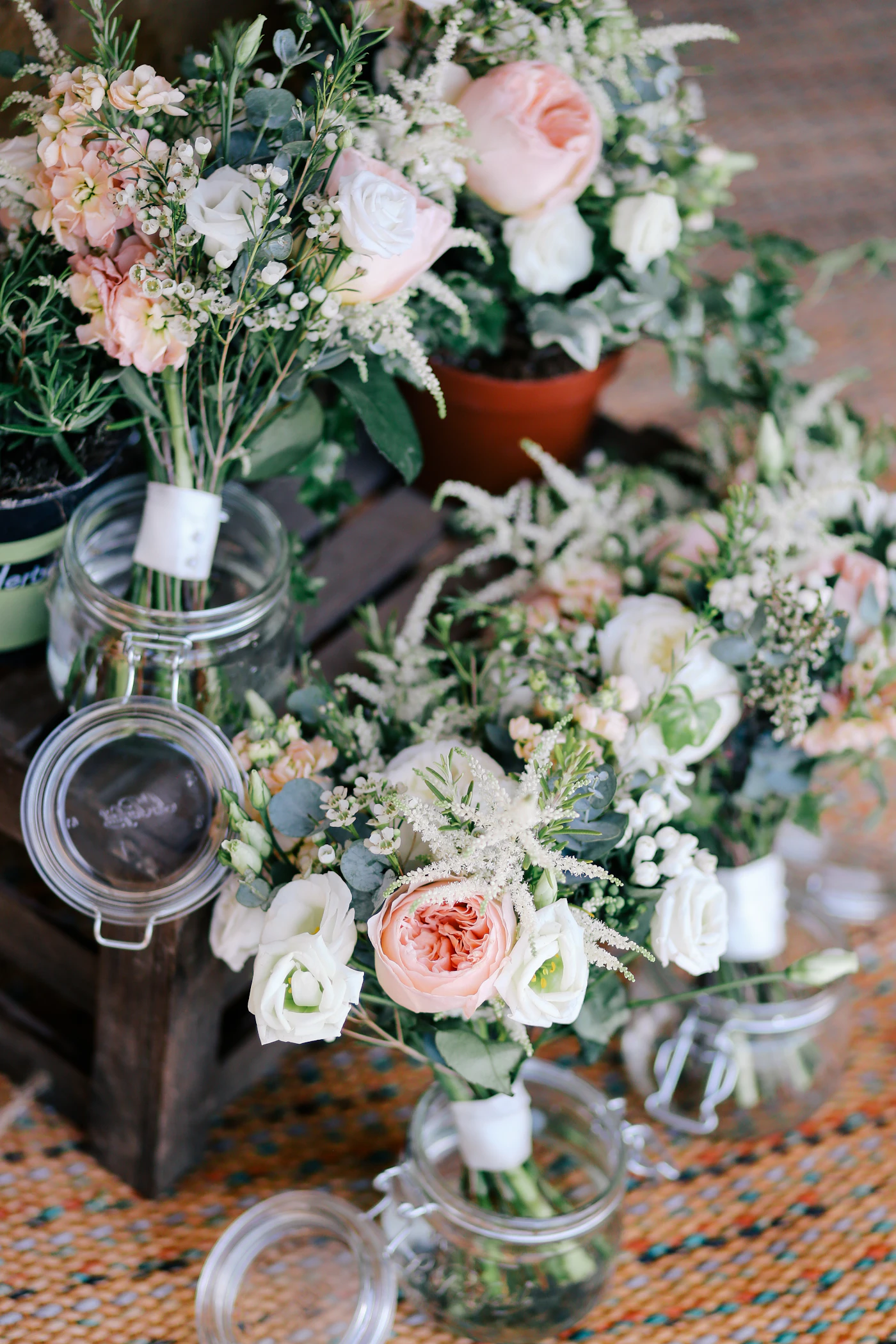 Pink and white floral arrangements in glass vases, reference photograph